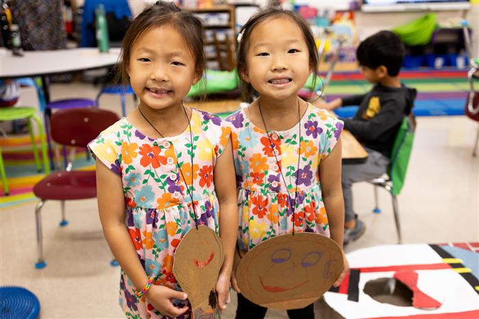 Two students standing next to each other wearing costumes